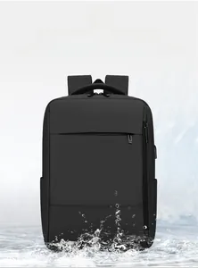 Detail of waterproof black business laptop backpack showing water splashing on the fabric