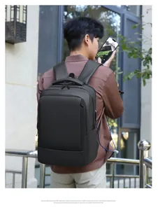 Detail view of water-resistant business backpack with external USB port on back of male model