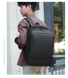 Minimalist black waterproof business backpack worn by model in city commute setting