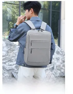 Sac à dos d'affaires Oxford gris clair imperméable porté par un modèle en déplacement