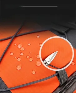 Close-up of orange waterproof nylon fabric with water droplets on hiking backpack