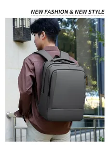 Rear view of dark grey business laptop backpack with wide ergonomic shoulder straps outdoors
