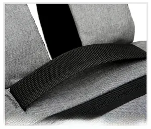 Detailed macro view of the reinforced black nylon handle on a gray oxford fabric backpack