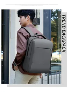 Detail view of a sleek grey professional business laptop backpack worn by a model