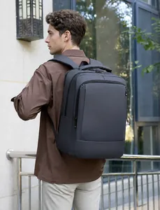 Waterproof business laptop backpack in charcoal grey shown from back on person
