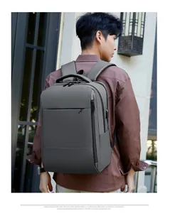 Close-up of grey business backpack showing USB charging port and minimalist side pocket