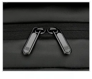 Detail of durable dual metal zippers on water-resistant black business backpack