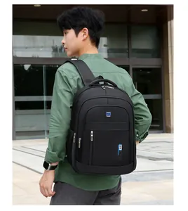 Outdoor view of a black high-capacity backpack with multi-layer zippers and side mesh pocket