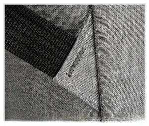 Macro detail of reinforced stitching on durable grey oxford fabric laptop backpack