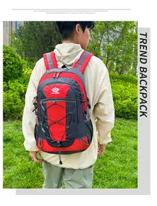 Detail view of red and black hiking backpack with dual zippers and elastic cords
