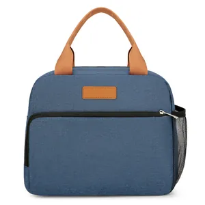 Sac à lunch isotherme en tissu oxford bleu avec poignées brunes et poche avant