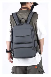 Side view of dark gray business backpack on male model showing strap fit and texture