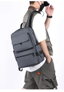 Detail of grey waterproof business backpack showing large main compartment and side buckles