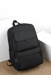 Detail view of water-resistant black business backpack with magnetic front pocket and zipper