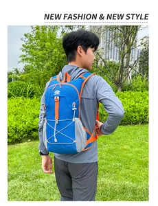 Outdoor cycling backpack with blue fabric and orange straps shown in nature