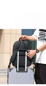 Detail showing the travel-friendly luggage strap on the back of a black business backpack