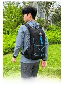 Black outdoor backpack with blue straps and mesh side pocket shown in a park setting