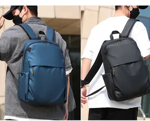 Detail view of business backpack showing side pocket with drawstring and waterproof fabric