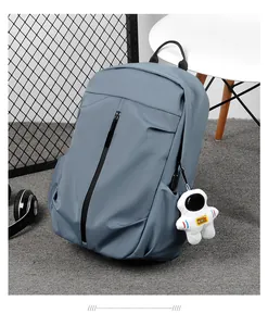 Detail of light blue waterproof backpack with creative astronaut pendant on side zip