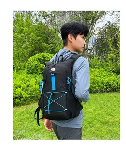 Detail of outdoor backpack with blue bungee cord system and durable black fabric straps
