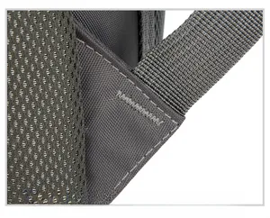 Macro detail of reinforced zigzag stitching and breathable mesh on backpack shoulder strap