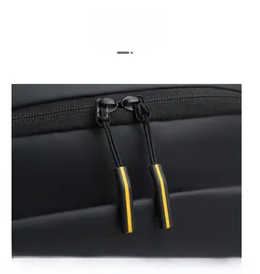 Close-up of black waterproof business backpack with yellow striped dual zippers