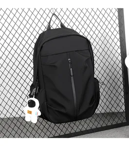 Detail of black leisure backpack with astronaut charm and vertical zipper pocket