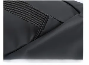 Detailed close-up of reinforced triangular bartack stitching on black backpack strap