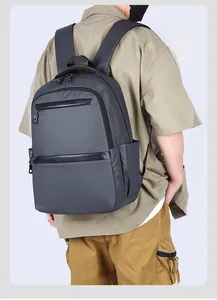 Detailed view of dark grey lightweight business backpack worn by male model for commuting