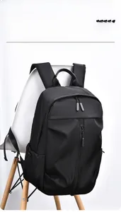 Detail of a lightweight black street fashion backpack featuring multi-layer zip pockets