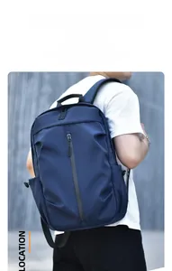 Street style navy blue waterproof backpack on male model showing back view and side pockets