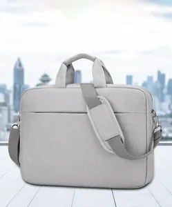 Detail of grey laptop bag with shock-absorbing shoulder strap and sturdy handles