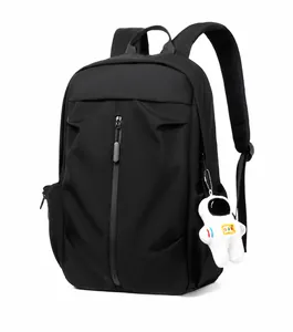 Detail view of black waterproof backpack featuring a vertical zip and astronaut plush charm