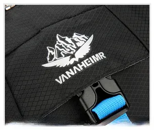Detail of tear-resistant diamond pattern fabric with VANAHEIMR embroidery and blue webbing