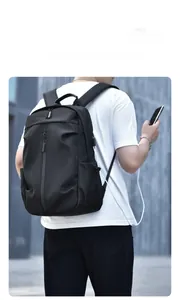 Detail of ergonomic black business backpack featuring integrated external USB charging port