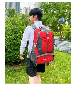 Rear view of an Asian male model wearing a 50L red and grey hiking backpack in a park