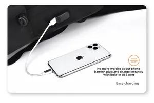 Close-up of black backpack featuring an external USB charging port with phone connected