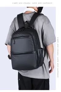 Male model wearing the black business backpack showing back view and actual size fit