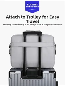 Gray laptop bag with back luggage strap feature for easy travel on suitcase handles