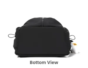 Detailed bottom view of the black nylon backpack featuring reinforced stitching and plush charm