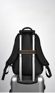 Detail of black backpack with integrated luggage strap for convenient travel luggage attachment