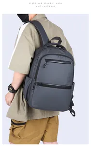 Business laptop backpack in dark grey waterproof nylon worn by a male model