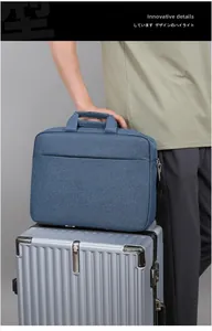 Detail of navy business laptop bag secured onto a silver textured suitcase handle