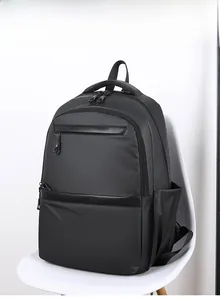 Detail view of large capacity black business backpack with multi-zipper compartments