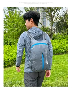 Close-up of lightweight grey hiking backpack with blue zippers and side mesh pockets