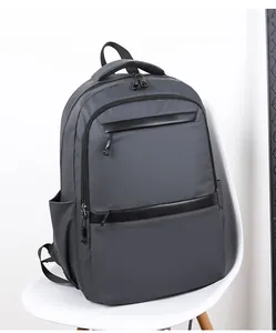 Close-up of waterproof nylon business backpack in dark grey with faux leather accents