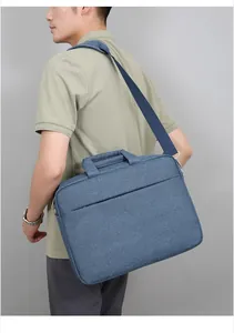 Light blue laptop bag with textured canvas and detachable navy blue shoulder strap