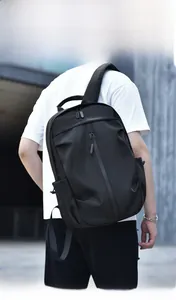 Outdoor model display of a minimalist black multi-functional backpack with durable fabric