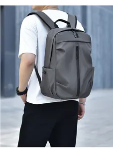 Side view of gray water-resistant backpack showing side pockets and padded straps