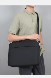 Detail of detachable shoulder strap with metal hook on black laptop briefcase bag